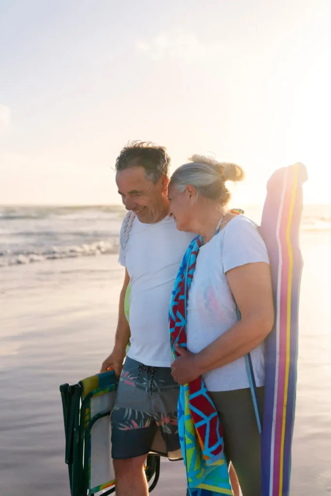 Older couple walking together on the beach