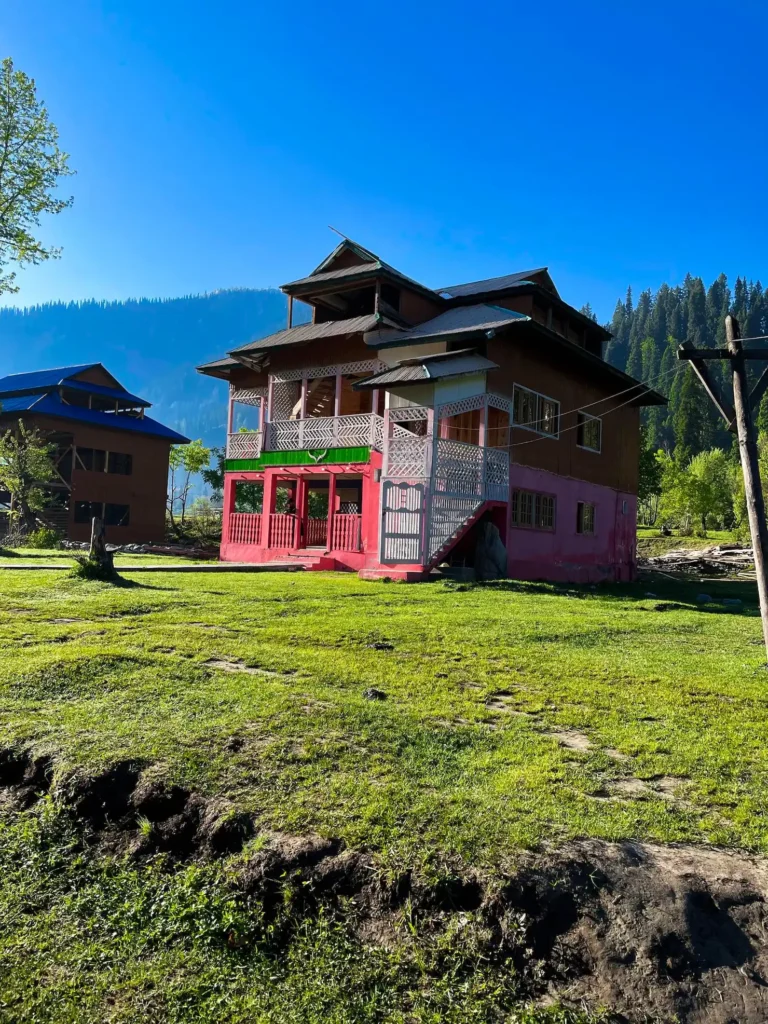Traditional house surrounded by lush green landscape