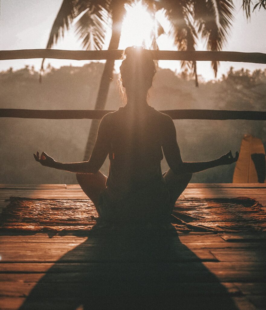 Active senior doing yoga on a tropical beach in Costa Rica, embracing longevity and wellness in the tropics