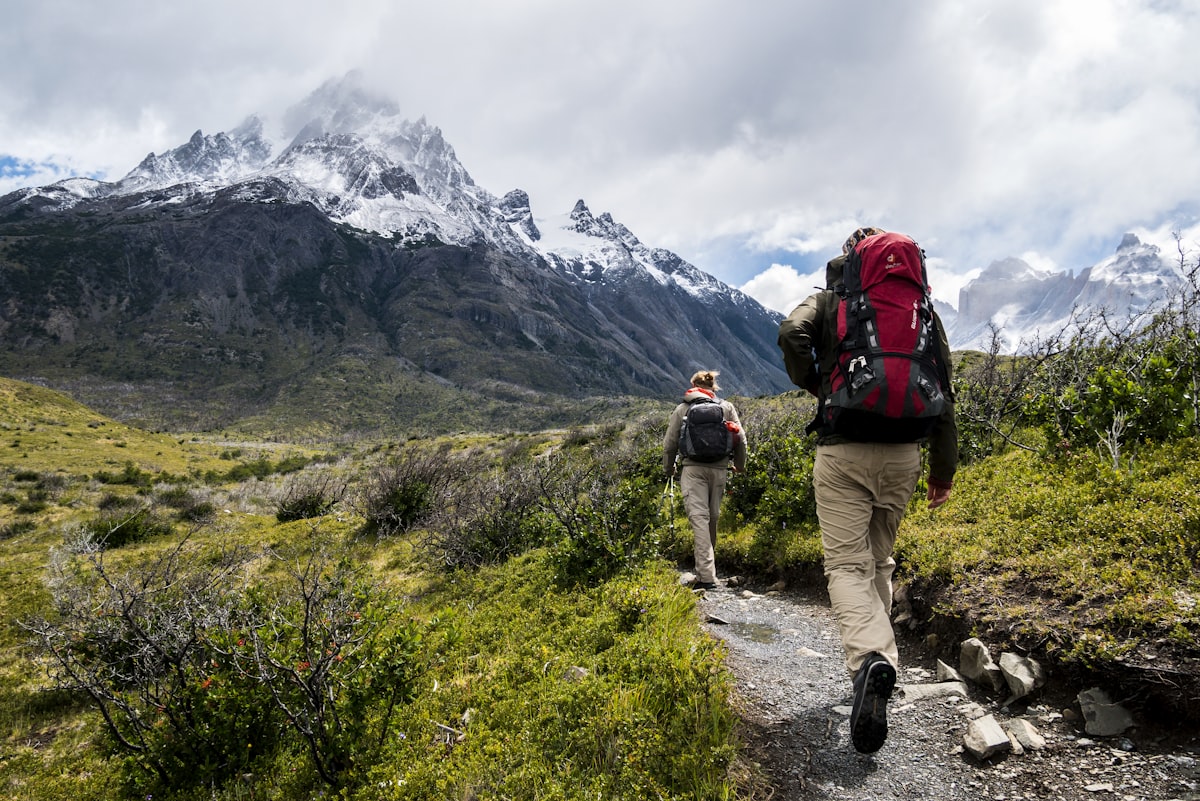 Hikers on a scenic Costa Rica trail leading to a waterfall, perfect for staying fit after 50